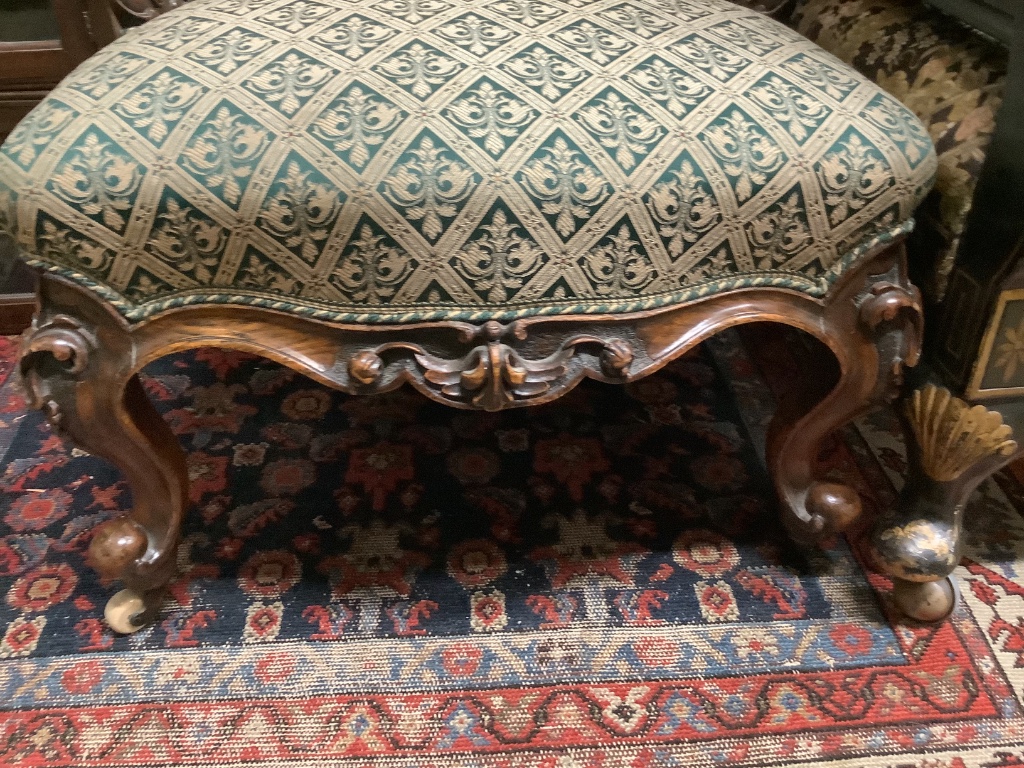 A Victorian carved walnut spoonback nursing chair